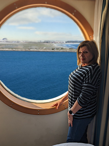 Patty at the stateroom port window
